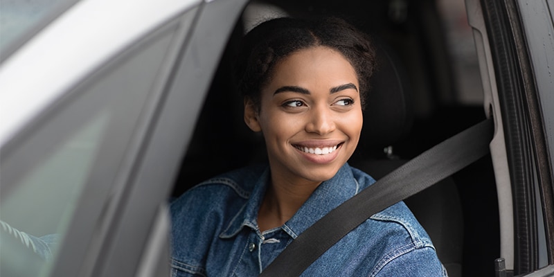 Photo Of A Woman Smiling Inside Of Her Car.