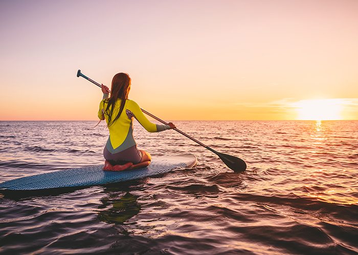 Photo Of A Girl Sitting On Inflatable Paddle Surf Board