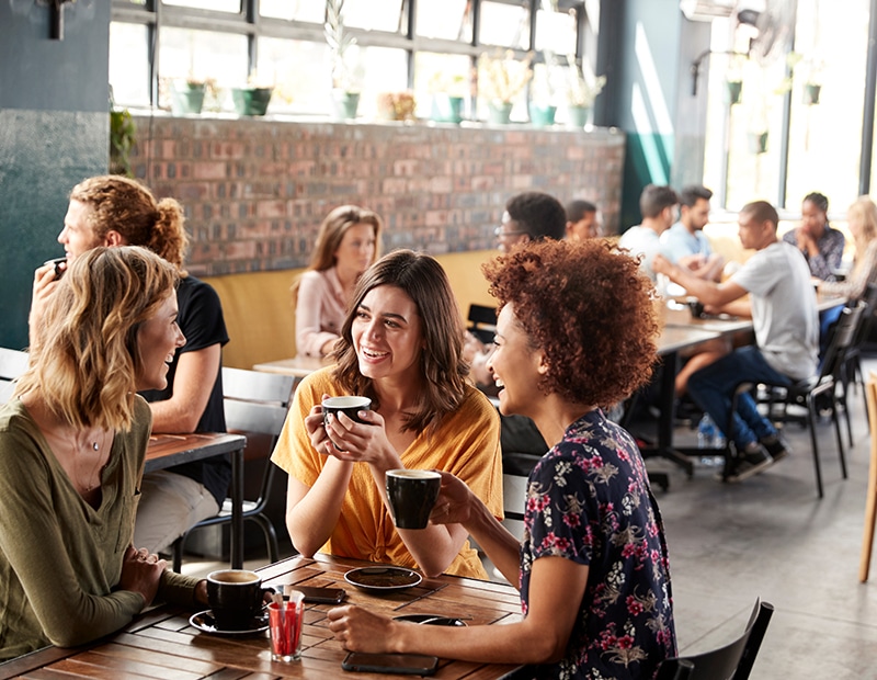 a group of people sitting at a table in a restaurant